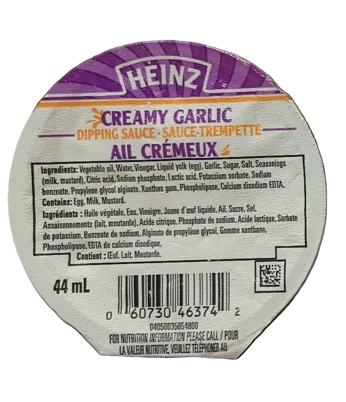 A round product label for Heinz Creamy Garlic Dipping Sauce, showing the brand name, product type, ingredients, barcode, and QR code on a white background.