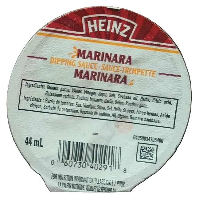A close-up of a round Heinz Marinara dipping sauce label, showing the brand name, product name, ingredients, 44 mL volume, barcode, and QR code on a black background.