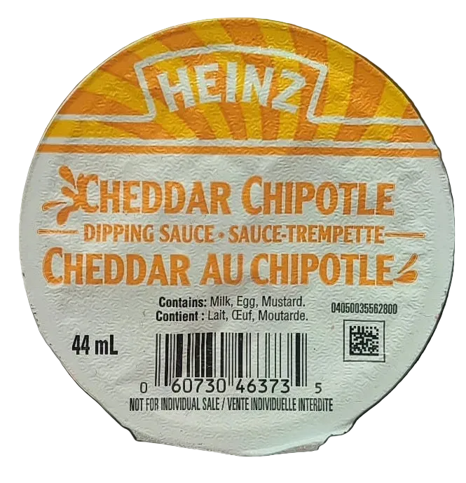 A round Heinz Cheddar Chipotle dipping sauce cup lid or label shown against a black background. The label features the Heinz logo at the top, with orange and yellow graphics and text reading 'Cheddar Chipotle Dipping Sauce' and 'Cheddar au Chipotle 2'.